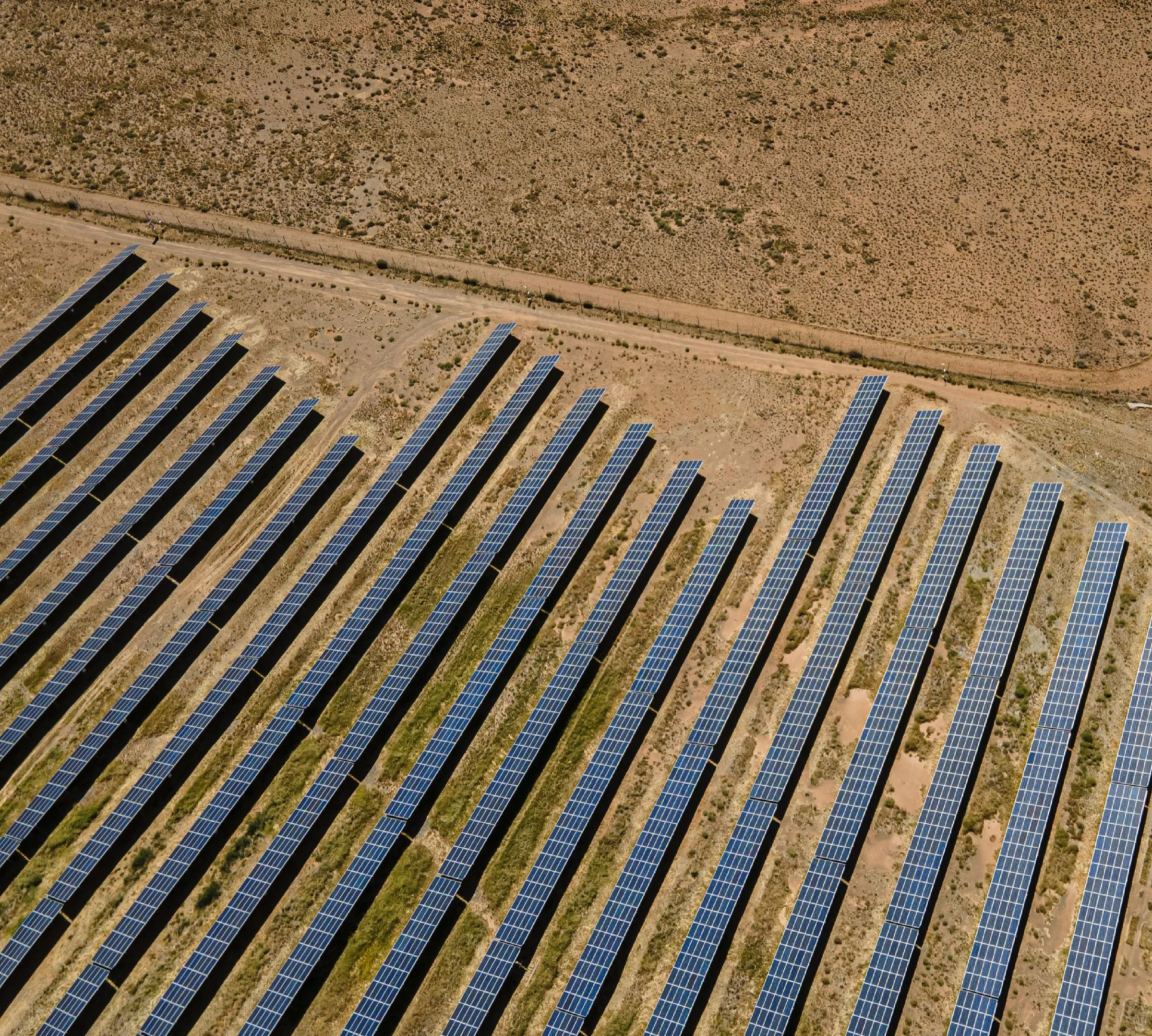 Aerial view of solar panel rows at a solar farm in De Aar, South Africa
